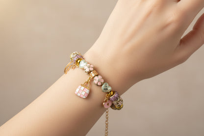 Pink Charm bracelet on a ladys wrist.